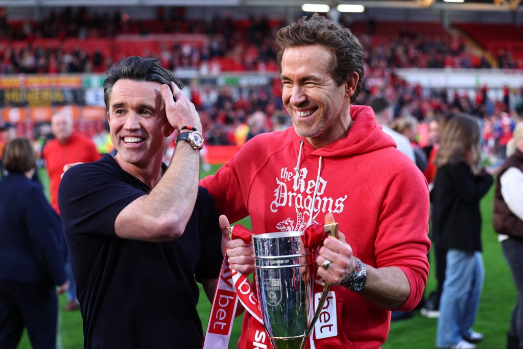 Rob McElhenney and Ryan Reynolds celebrate Wrexham winning promotion with victory over Charlton Athletic.