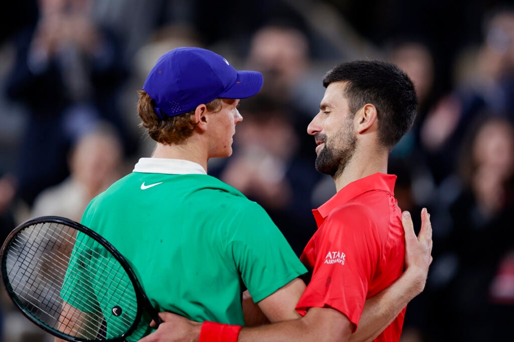 Jannik Sinner and Novak Djokovic embrace after their match at the 2025 French Open.