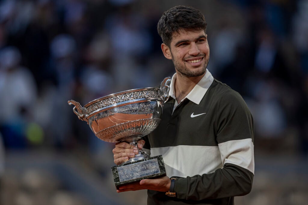 Carlos Alcaraz holds the trophy after the match at the Roland Garros Grand Slam Tournament Men's Final in Paris.