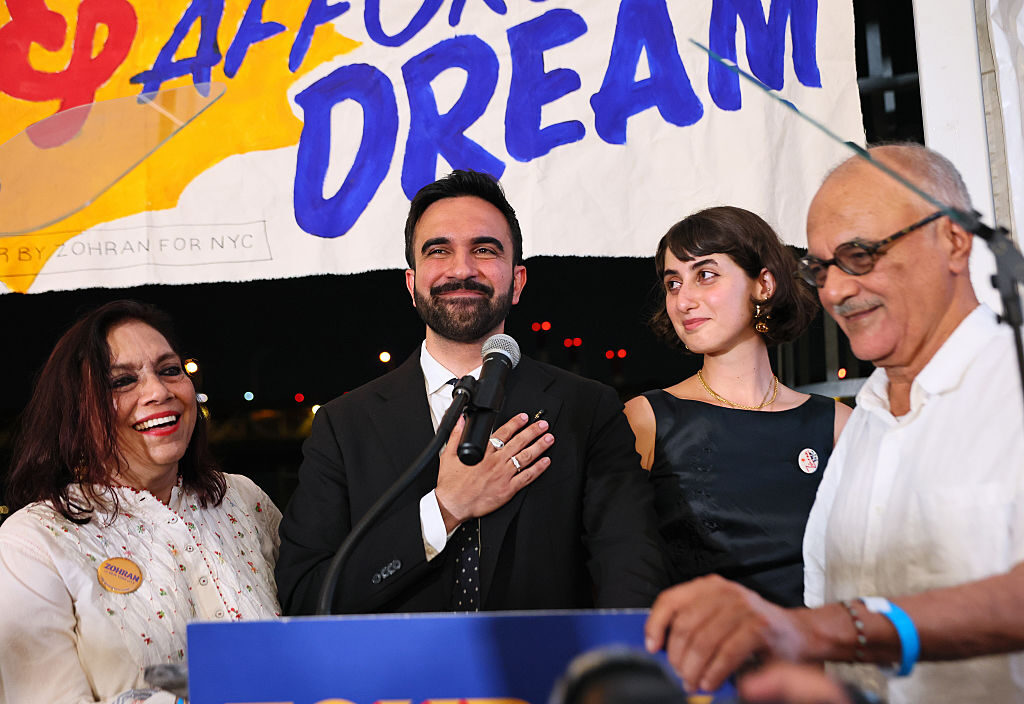 New York Assemblymember Zohran Mamdani, center, celebrates at an election night gathering in Queens on Tuesday. He is flanked by his wife, Rama Duwaji, second from right, and his parents, filmmaker Mira Nair and Columbia professor Mahmood Mamdani.