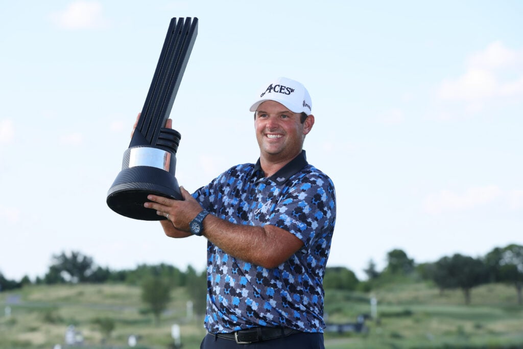 Patrick Reed lifts the trophy after winning LIV Golf Dallas