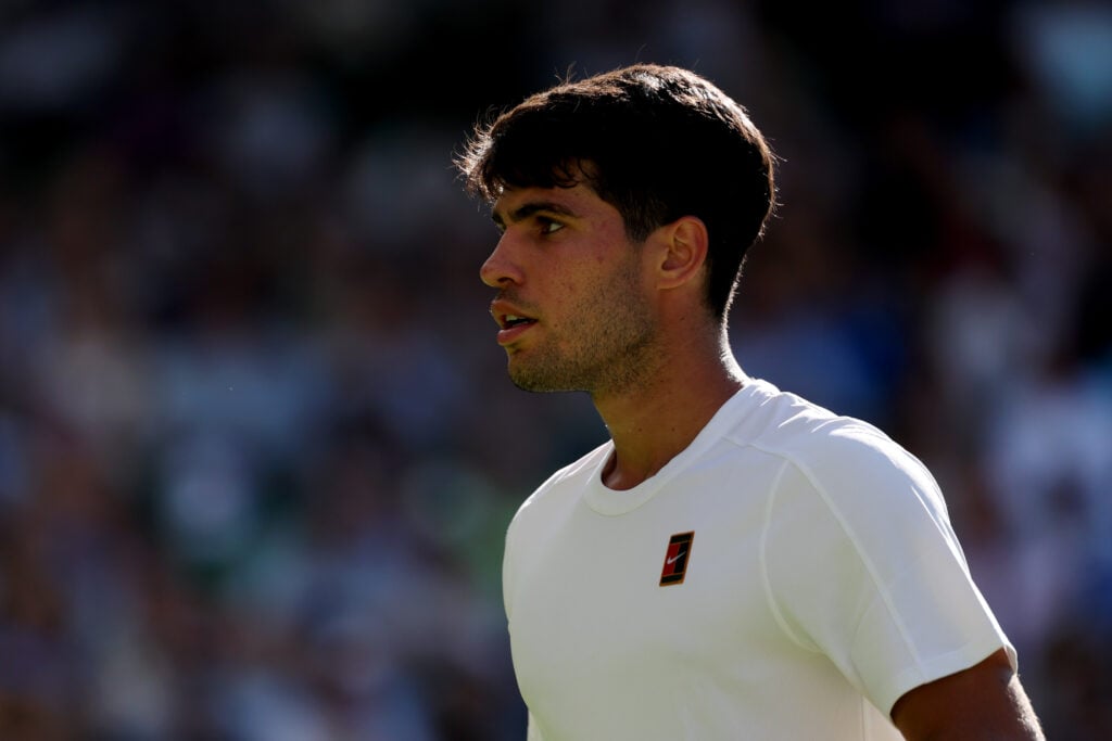 Carlos Alcaraz of Spain reacts against Fabio Fognini of Italy during the Gentlemen's Singles first round match on day one of The Championships Wimbledon 2025 at All England Lawn Tennis and Croquet Club.