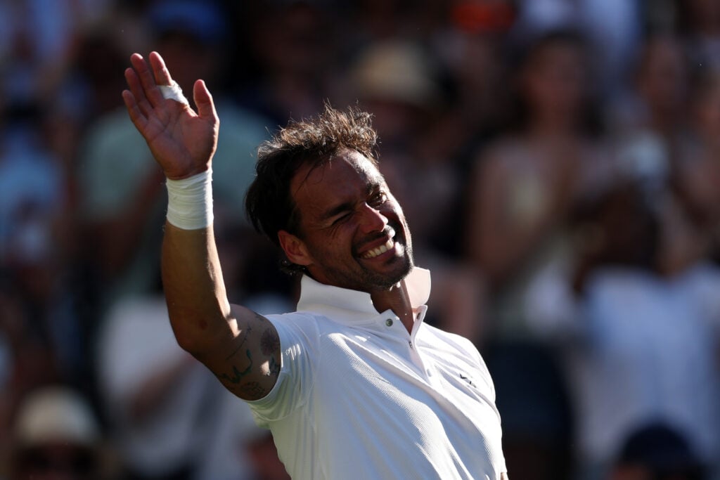 Fabio Fognini waves goodbye to the crowd after losing to Carlos Alcaraz at Wimbledon in 2025