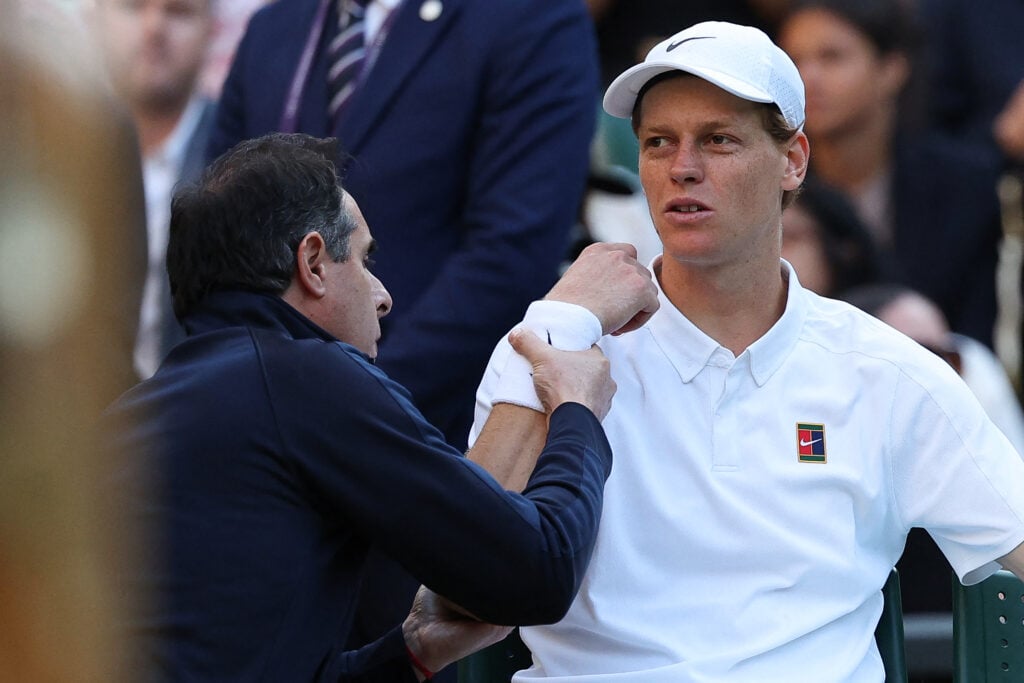 Jannik Sinner receives treatment during his fourth-round match with Grigor Dimitrov at Wimbledon