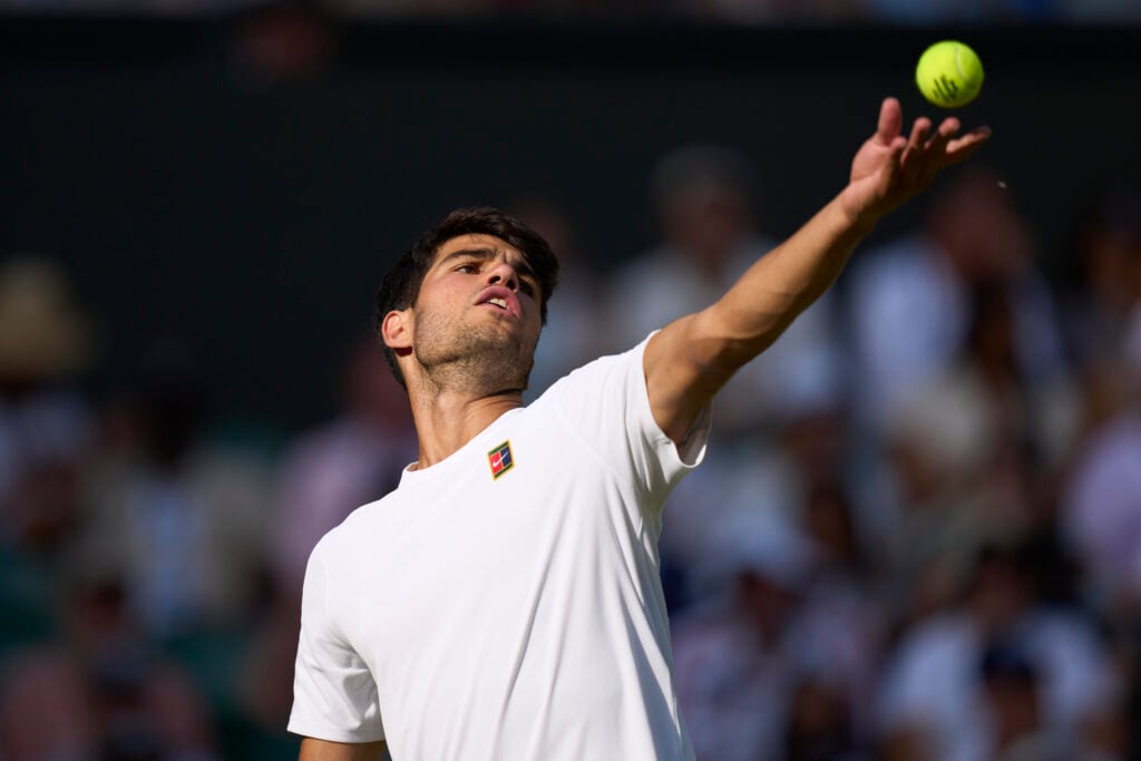 Carlos Alcaraz of Spain serves the ball against Jan-Lennard Struff of Germany on Centre Court during the Gentlemen's third round match on day five of The Championships Wimbledon 2025 at All England Lawn Tennis and Croquet Club.