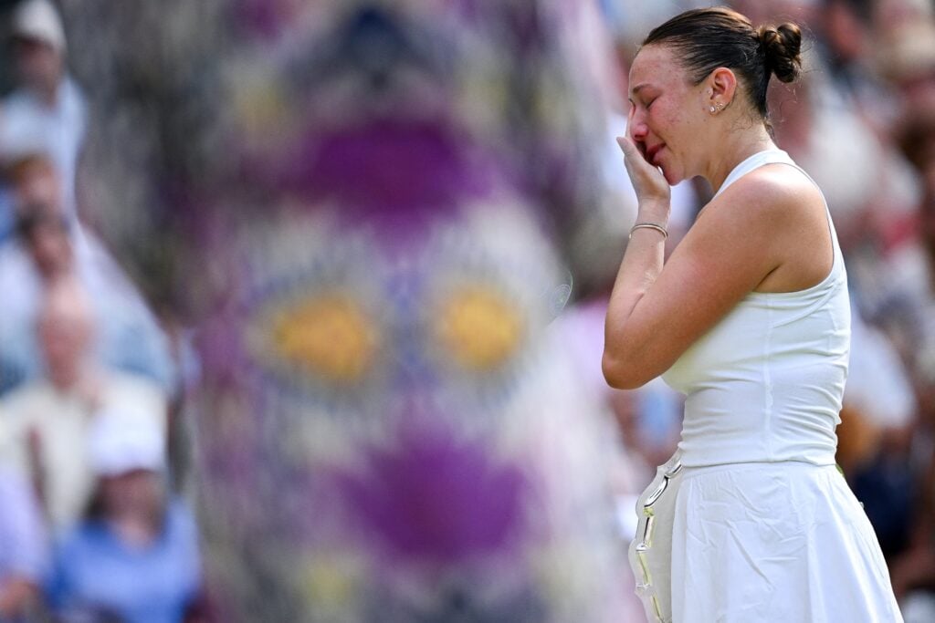 Amanda Anisimova wipes away tears after her Wimbledon final defeat to Iga Swiatek