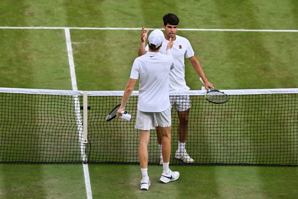Italy's Jannik Sinner shakes hands with Spain's Carlos Alcaraz after winning their men's singles final tennis match on the fourteenth day of the 2025 Wimbledon Championships at The All England Lawn Tennis and Croquet Club in Wimbledon, southwest London, on July 13, 2025.