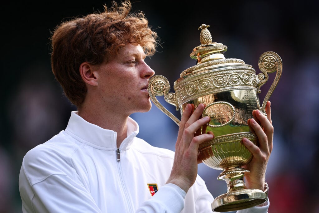 Jannik Sinner kisses the Wimbledon trophy after beating Carlos Alcaraz in the 2025 final