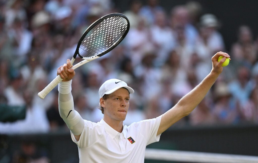 Jannik Sinner celebrates at Wimbledon after defeating Novak Djokovic.