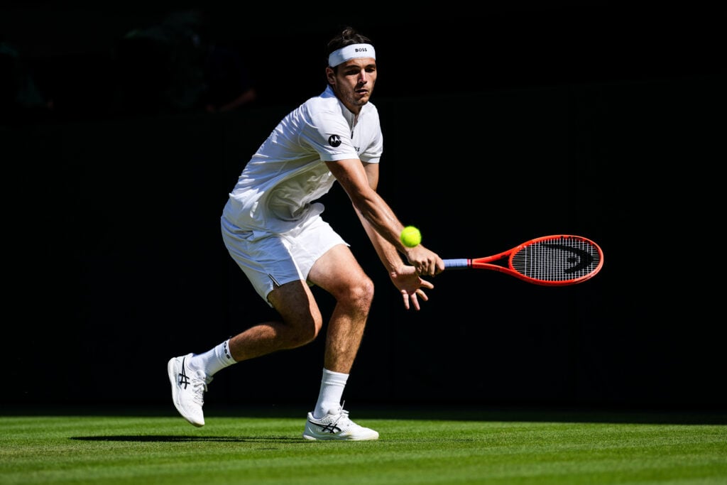 Taylor Fritz plays a backhand during the 2025 Wimbledon semi-final