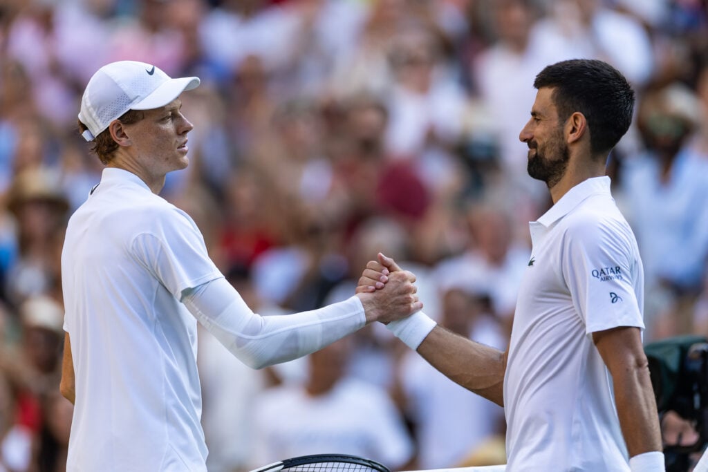 Jannik Sinner and Novak Djokovic shake hands at the net following their Wimbledon semi-final in 2025.