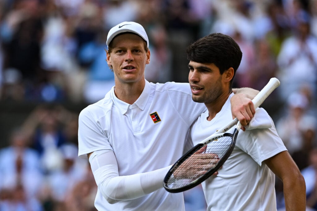 Jannik Sinner and Carlos Alcaraz embrace after the 2025 Wimbledon final