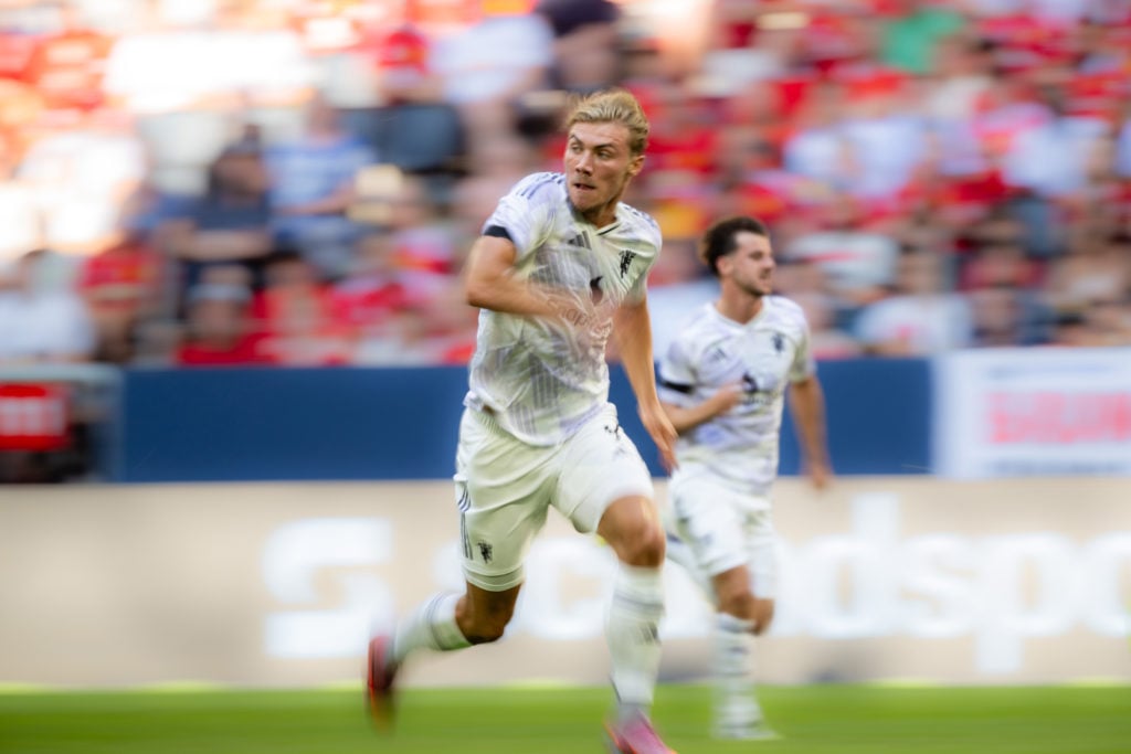 Rasmus Hojlund sprints in pre-season friendly, white kit