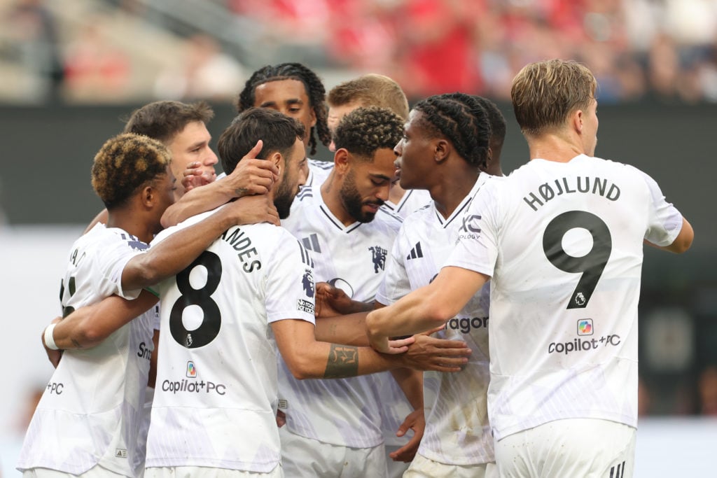 Manchester United players celebrate goal.