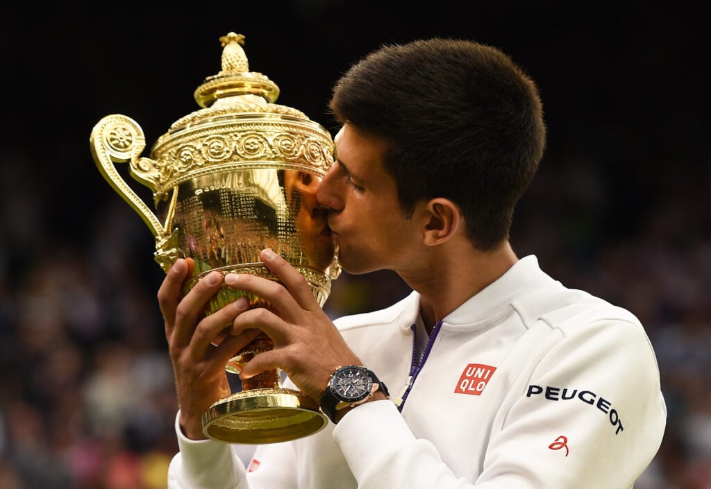 Novak Djokovic kissing the 2015 Wimbledon title.