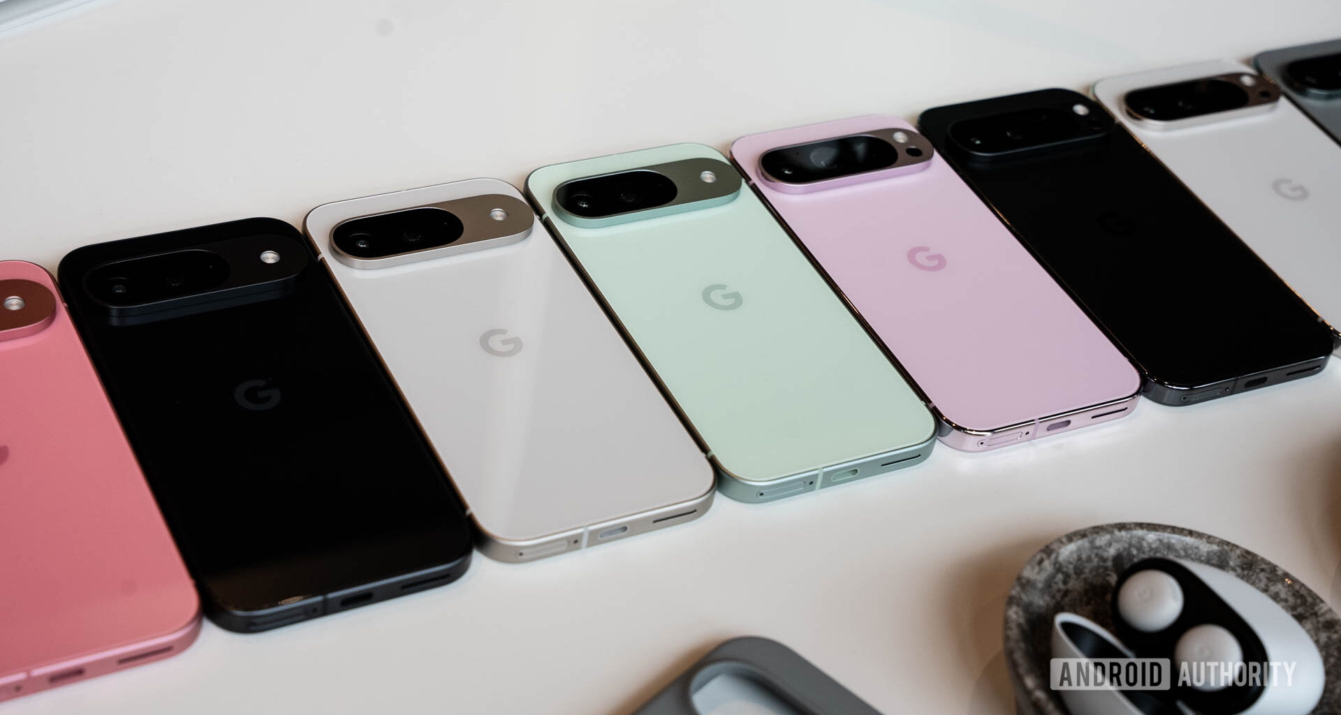 Google Pixel 9 family lined up face down on a table in multiple colors
