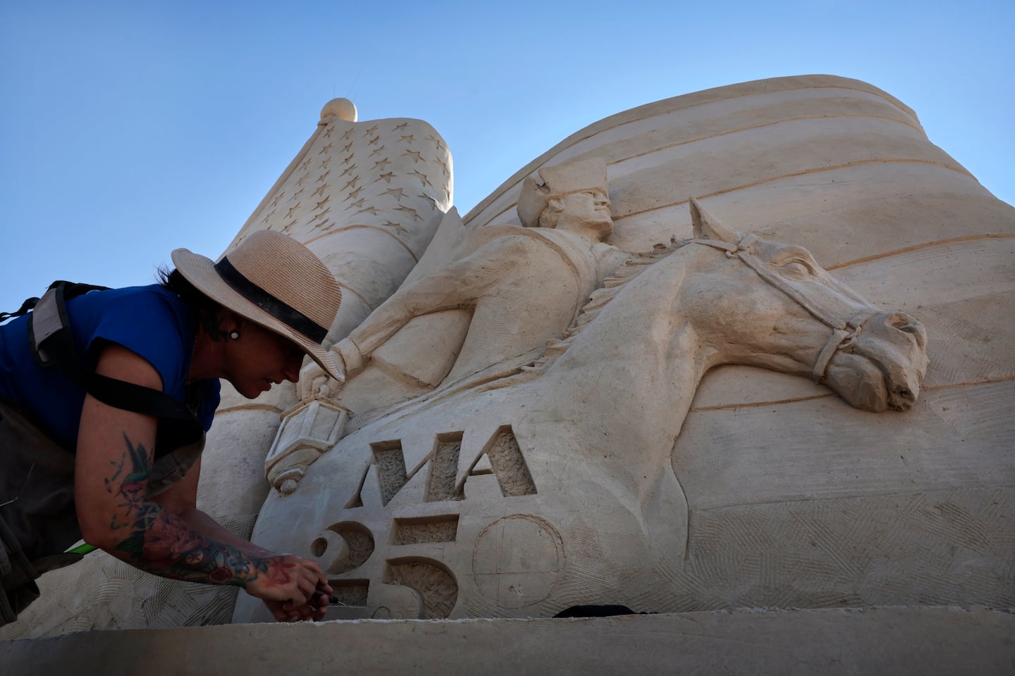 Sculptor Melineige Beauregard worked on “Revolutions Start Here,” the centerpiece of the 21st annual Revere Beach International Sand Sculpting Festival.