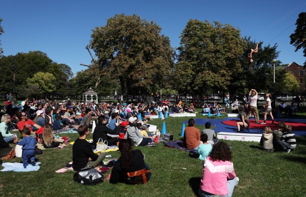 People watch the Midnight Circus perform at Humboldt Park on...