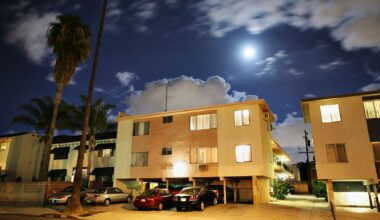 An apartment building with cars parked out front