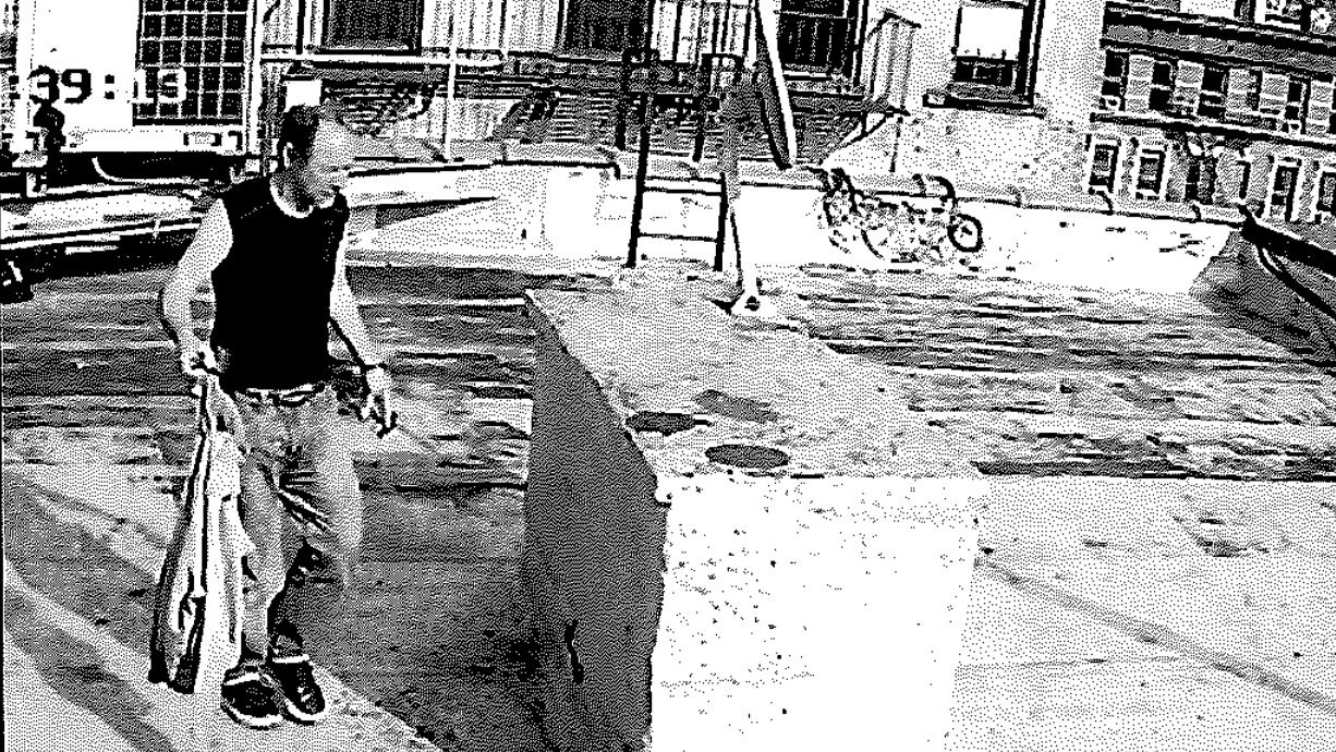 This undated image from surveillance video, provided by the U.S. Attorney's Office for the Southern District of New York, shows a man identified by prosecutors as Michael Gann carrying what an indictment says are improvised explosive devices on the rooftop of a residential apartment building in SoHo. (U.S. Attorney's Office, Southern District of New York via AP)