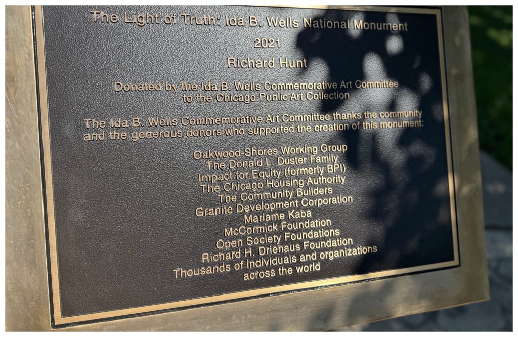 A plaque honoring late artist Richard Hunt and donors who made the 'Light of Truth" monument possible was unveiled in a special ceremony July 18.