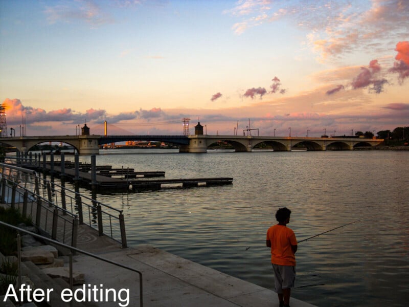 A person in an orange shirt fishes by the water at sunset, near empty docks and a bridge under a partly cloudy sky. White text at the bottom left reads "After editing.
