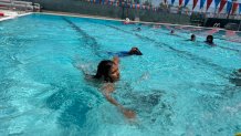 Aiden Laguna learns to swim in the City Heights pool, July 24, 2025.