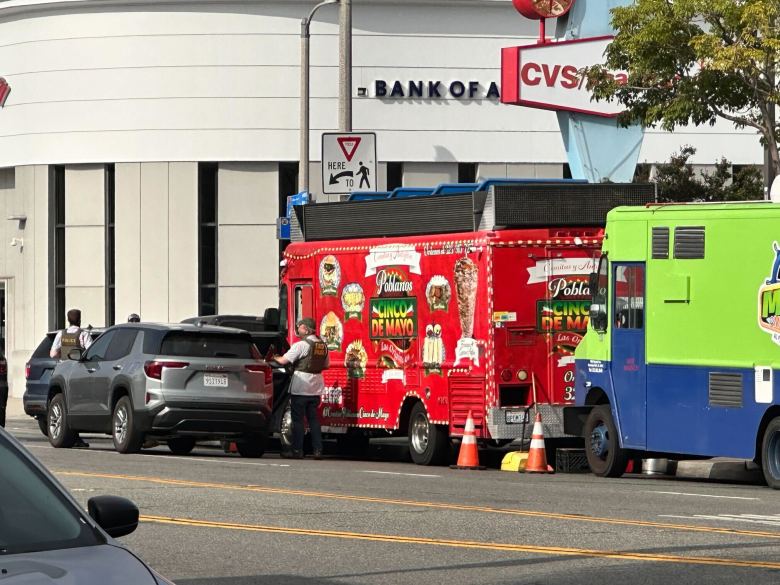 Agents are seen at a street vending site in East LA