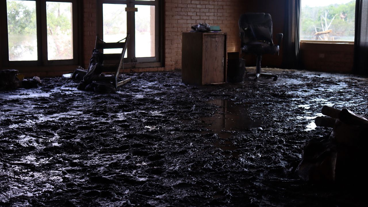 Max Duncan's office covered in inches of mud and debris after the July 4 Guadalupe River flood. (Spectrum News 1/Andres Rendon)