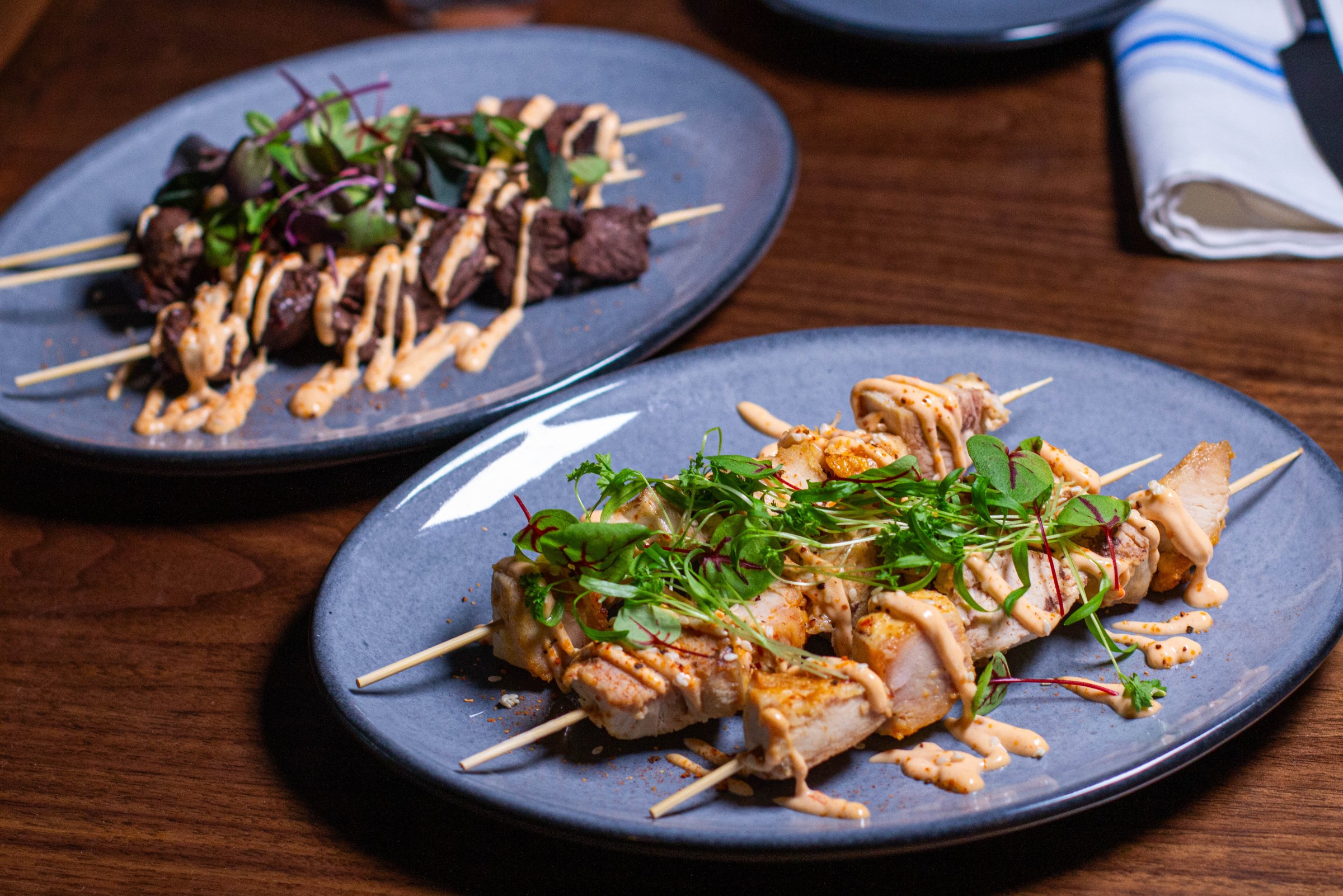 Two plates with skewers.