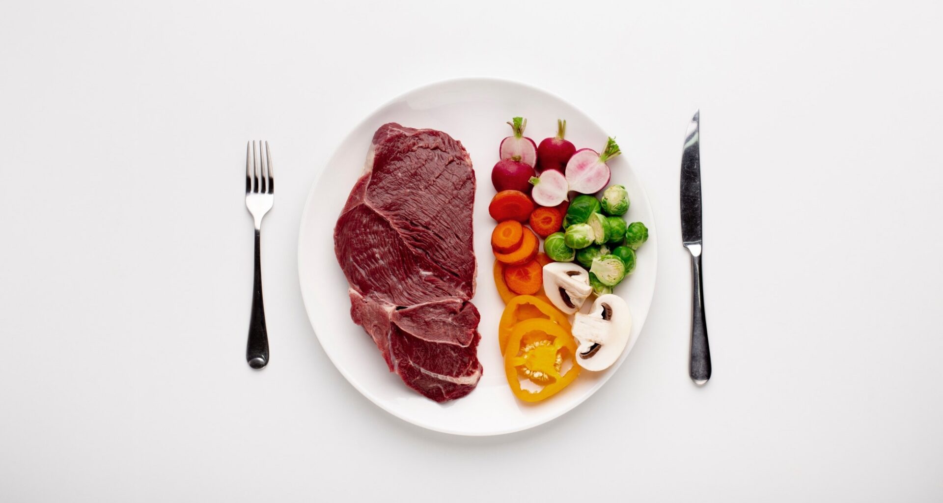 Served plate with meat and vegetables, top view