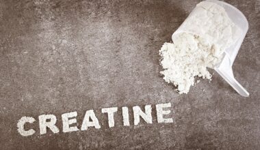 Creatine powder text font on grey stone background with plastic spoon cup