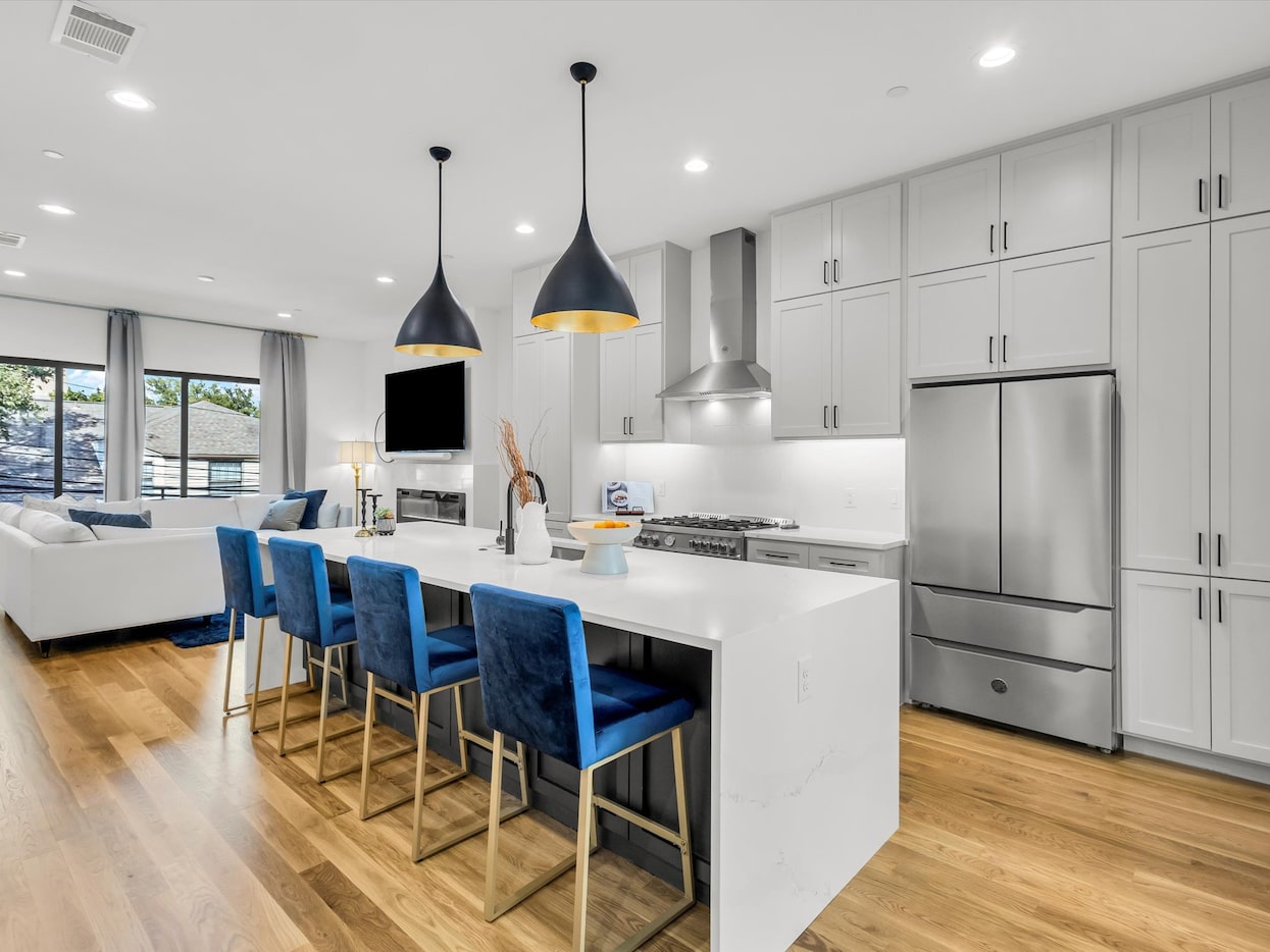 On the second floor of this Pavillion Street townhome, a chef's kitchen with a waterfall...