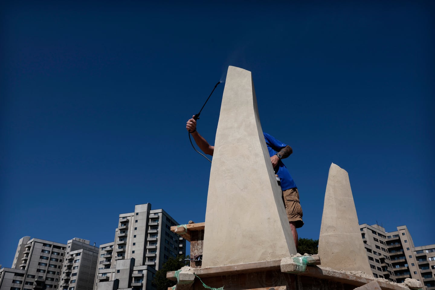 Bruce Phillips, of San Diego, CA, sprayed down a column of sand.