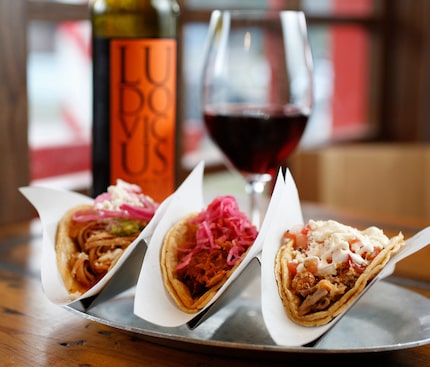 Tacos (from left) chicken tinga, chochinita pibil and crispy pork carnitas at Taco y Vino in...