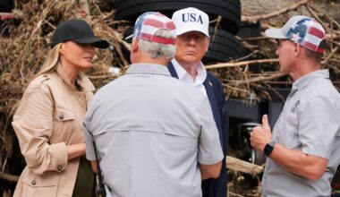 First lady Melania Trump, left, and President Donald Trump, second right, greet first responders as they observe flood damage in Kerrville, Texas, Friday, July 11, 2025. (AP Photo/Jacquelyn Martin)