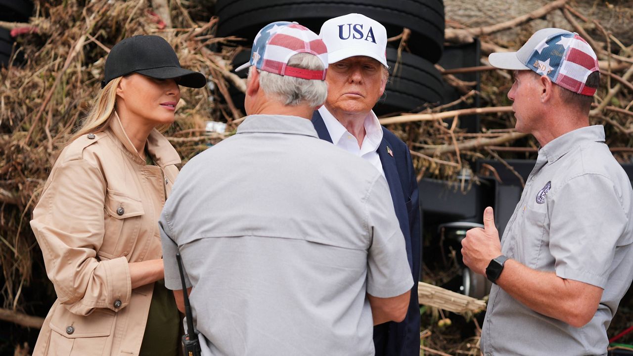 First lady Melania Trump, left, and President Donald Trump, second right, greet first responders as they observe flood damage in Kerrville, Texas, Friday, July 11, 2025. (AP Photo/Jacquelyn Martin)