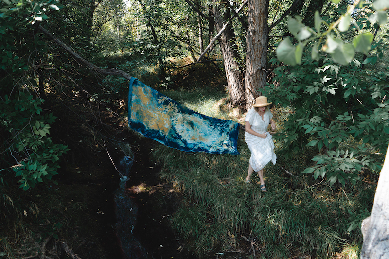 Kristen Abbott in the woods creating a cyanotype