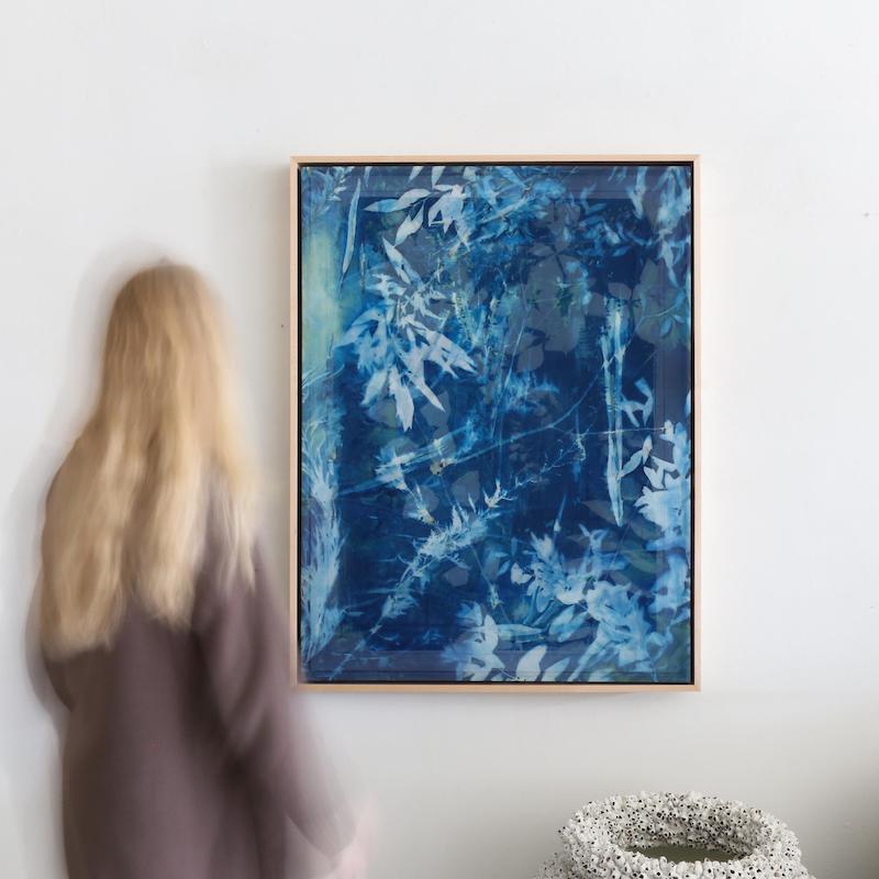A Kristen Abbott cyanotype hanging on the wall