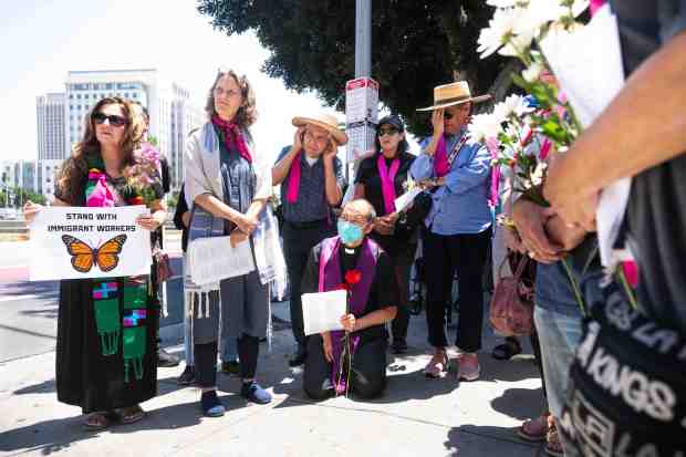 An interfaith gathering listens to stories outside the Metropolitan Detention...