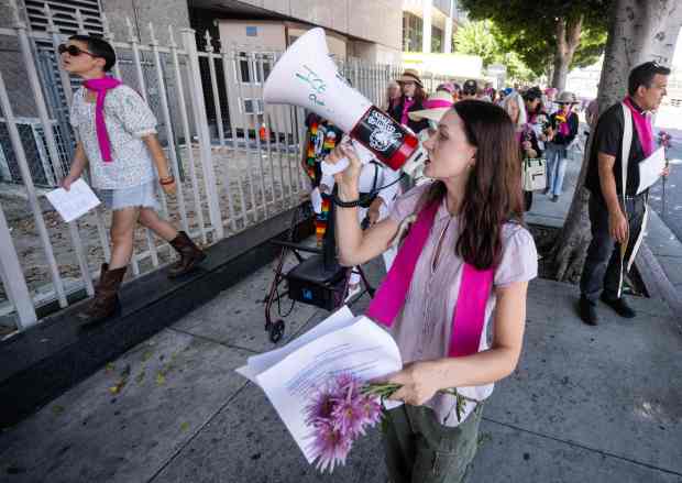 Zoe Kisselbach, of Hollywood, leads an interfaith gathering during their...