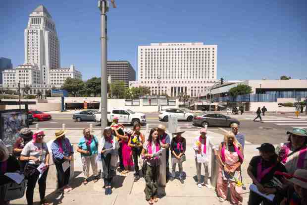 An interfaith gathering begins their weekly vigil at the Federal...