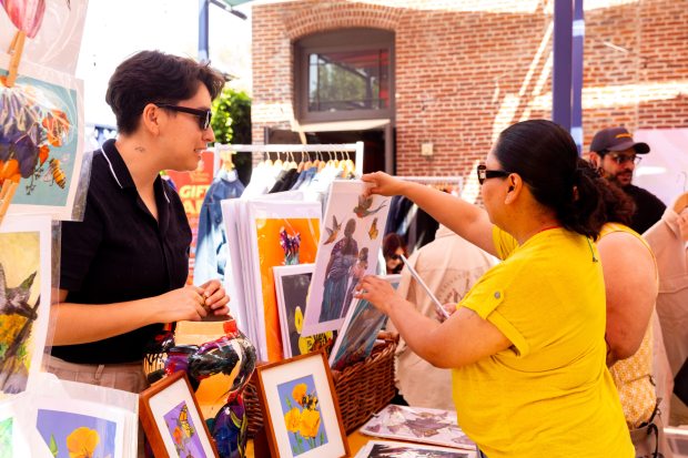 An attendee of last year’s “Jotería” festival looks through a...