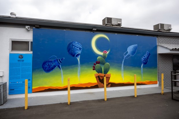A mural entitled “Sabr at Fajr” by Artist Saj Issa...