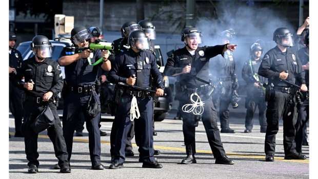 LAPD officers prepare to push back protesters along First Street...