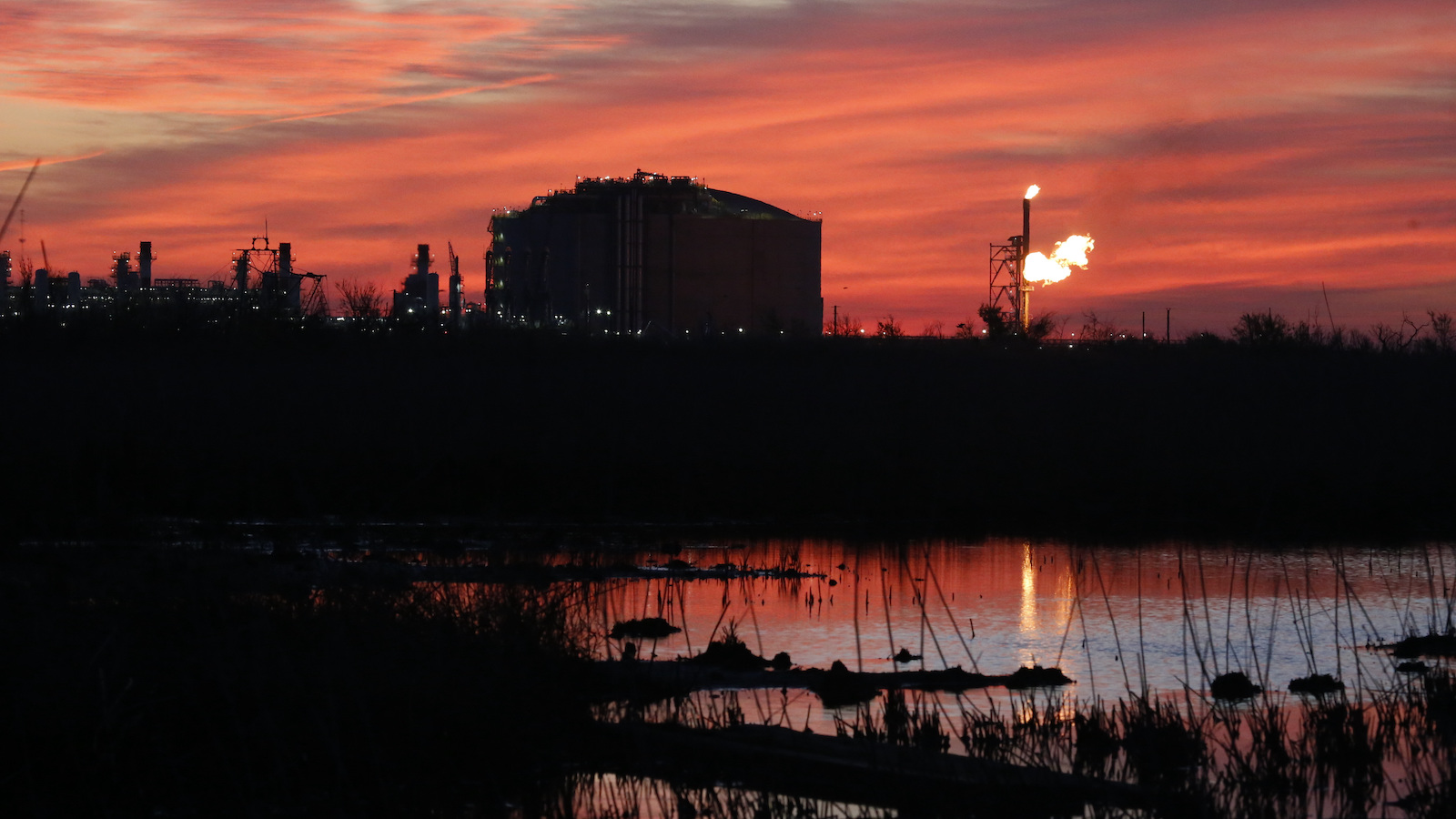 Flares of light against a red sky.