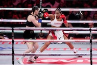 Puerto Rico's Amanda Serrano, right, punches Ireland's Katie Taylor during the second round...