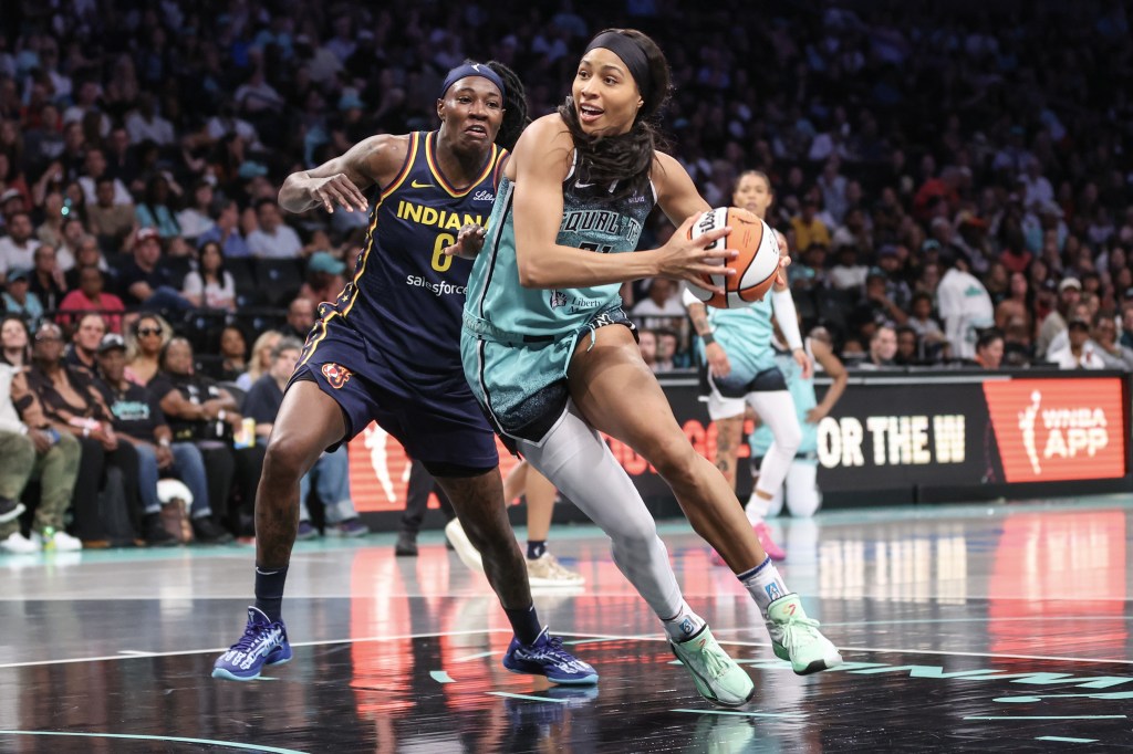 New York Liberty's Isabelle Harrison dribbling the ball during a game against the Indiana Fever.
