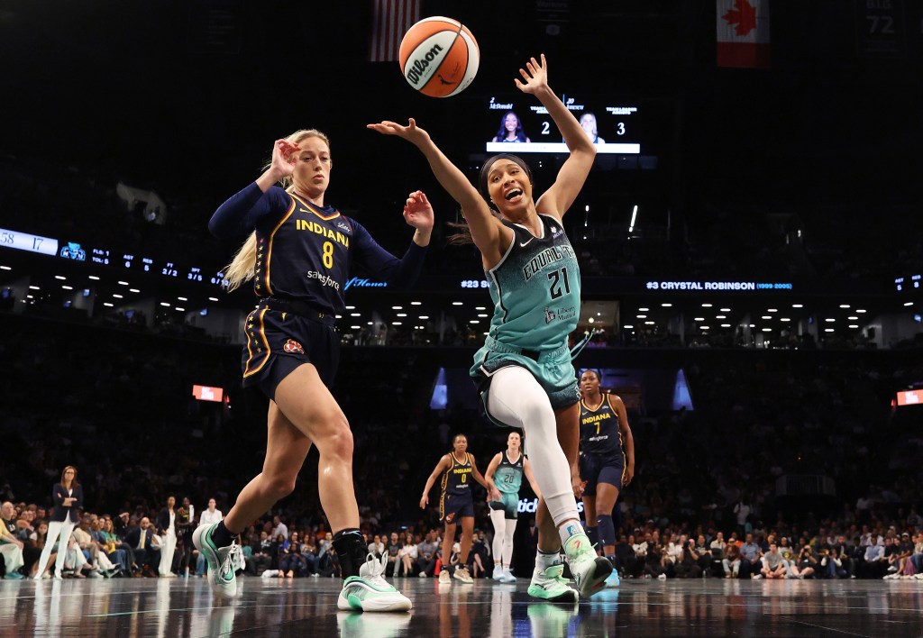 Isabelle Harrison of the New York Liberty goes for a rebound as Sophie Cunningham of the Indiana Fever defends.
