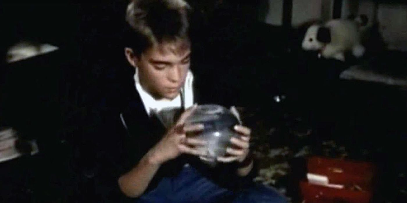 Tommy Westphall looking at his snow globe, distracted and daydreaming, in the St. Elsewhere series finale.